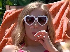 Blonde Simone Sonay in pink bikini flashes her small tits in the garden and then gets punished by Ramon Nomar indoors. Cutie gets ball gagged and tied up before she gets her ass whipped.