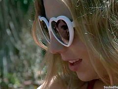 Blonde Simone Sonay in pink bikini flashes her small tits in the garden and then gets punished by Ramon Nomar indoors. Cutie gets ball gagged and tied up before she gets her ass whipped.