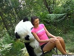 Naughty teen gets dirty with kinky panda bear. He flirts with her, she gets naked and ends up sucking his huge rubber cock.