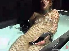 Redhead girl gets her tits pinched and pussy toyed. After that the guy wraps her into the net and puts in an aquarium.