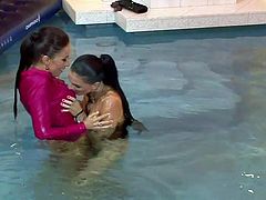 Sexy lezzies are bathing in water in their clothes. Tracing their hands over each other's bodies they get horny. So, they start spicy lesbian sex right in the pool.