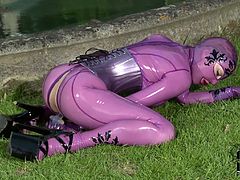 Latex Lucy is wearing pink latex and spreads her pussy with her favorite dildo outdoors! She enjoys every inch of it and sticks it deep!