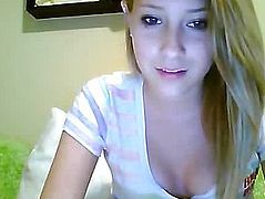 Blonde in a striped blouse sitting in front of webcam
