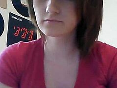 Girl in pink blouse communicates via webcam