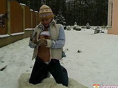 Crazy blond whore strokes her snatch with glove covered hand in snowy weather