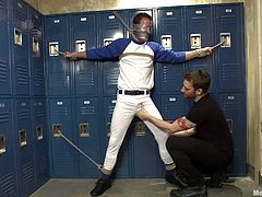 Sport guy gets tied up by another dude. Then he gets his dick sucked and ass toyed with big dildo in the dressing room.