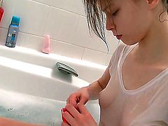 Good looking slender teen brunette Beata with nice firm natural boobs and long legs in white t-shirt gets filmed in close up while shaving her tight cunny in warm bathtub.