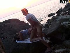 Don't miss this hot scene where a couple gets down and dirty outdoors, by the sea in the rocks. Girl bends over and gets her pussy nailed from behind.