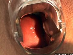 Brunette spreads legs wide and gets pussy lips stretched with vaginal speculum