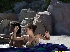 Stunning brunette chicks with big tits relax in hot whirlpool outdoors. Then they start to kiss and lick each others wet pussies.