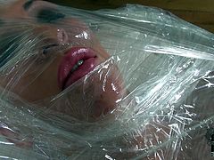 This girl must have done something very bad to be locked in a clear wrap. Extremely perverted hottie gets her tits and pussy stimulated with vibrator in this wild BDSM video.