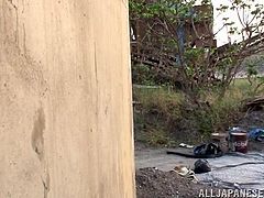 This cute Japanese babe has come across a tired construction worker at a construction site. She offers to give him a blowjob and he is very happy. She kneels down in the gravel and pulls his cock out of his pants and sucks him off.