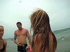 Beefy utterly sexy dude notices two fuckable young chics lying at the beach taking a sunbath. He offers them to swim in the ocean wearing tiny raunchy swimsuits in peppering sex clip by Pornstar.