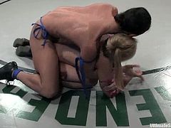 Sarah Jane Ceylon and Wenona are two kinky chicks in bikini. They wrestle in a ring and the blonde loses the fight. So, she gets her vagina drilled from behind.