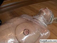 Damn, this is my worst fear to be wrapped in motionless position. Katja is doing pretty well. I wonder how she bears this position with her face wrapped in plastic. Anita makes it even worth by tickling her pussy hole.