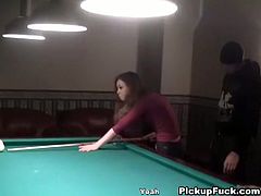 This babe is playing pool with two guys. They keep offering her money from stripping, until she is completely naked and sucking.