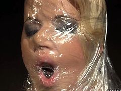 Extremely perverted blondie with big tits finds herself naked and covered in a clear wrap. Even her face is covered with the transparent wrap. Check out this BDSM scene now and enjoy the show.