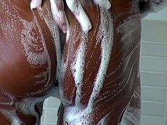 Juggy Latin MILF with delicious milky tits washes her steamy body in shower using aromatic foam before she takes a slim ruffled dildo to poke her shaved cunt with it.