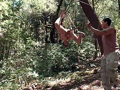 Logan Stevens gets tied up, gagged and blindfolded somewhere in a forest. Then he gets his ass toyed rough by another man.