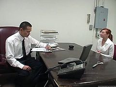 Naughty red haired secretary is about to give her boss steamy blowjob. She unbuttons her blouse and he starts to play with he juicy tits.