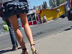 Horny voyeur feels horny while upskirting blonde's panties in public session
