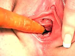 This beauty hasn't felt cock in a long time, so she would put anything that looks like a dick inside her love hole. This time she goes for a carrot.