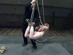 Redhead girl gets tied up and whipped with a stick. Then the master fixes clothespins to her pussy and toes. Later on he also drills her vagina with a dildo.