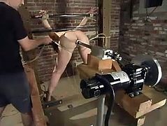 This bound girl gets her tits pinched with steel claws. After that she gets her pussy destroyed by the fucking machine.