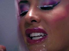 Cock loving whore Helly Mae Hellfire with colorful heavy make up and kinky wig dressed as Lady Gaga gets her pretty face sprayed with cum in close up during provocative parody.