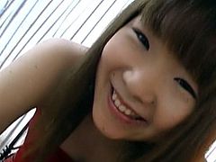 Slender Asian model is smiling in the cam