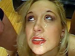 Alluring blonde receives warm loads splashing her face during rough bukkake orgy