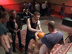 They've tied his hands and now, all those horny guys are playing with his nipples, and cock. Everybody wants a piece of him and soon, he's knelt and they start fucking his mouth, without removing that pumpkin from his head. Seems, that our boy has a lot to work on and the guys won't leave him, until they are satisfied