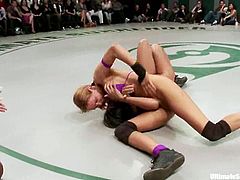 Three chicks in bikini wrestle in a catfight show. Then one of the girls gets her pussy licked and fingered right in a ring in public.