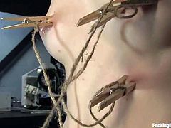 Stunning blonde chick toys her pussy with a vibrator and fondles her nipples. After that she fixes clothespins to her boy and gets drilled by the fucking machine.