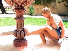 Press play and get a load of this blonde's teen's huge natural tits in this solo scene where she shows them off in public.