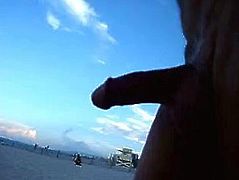 naked dude walking on the beach and masturbates his dick