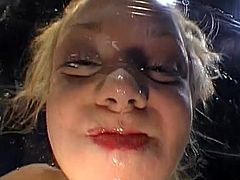Slutty blonde receives massive load to cover her face during nasty porn scene