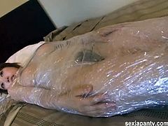 Checkout this sexy busty Japanese brunette babe Jun Kubota in this hot video, where you will see her all wrapped up in a thin plastic sheet.Then this lucky dude, takes the advantage and fingers her hairy pussy nicely, while she moans in the pleasure.After that he takes off all the wrapped plastic and fucks this hot bitch hairy pussy.