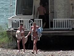 Get a hard dick watching this lesbian babes, with huge knockers wearing white bikinis, while they have sex outdoors on the beach after being in a yacht.