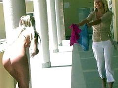 Have a good time watching two blonde babes, with natural breasts and nice asses, while on of them plays with a vibrator and the other ones stares.