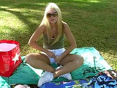 Prepare your cock for this blonde babe, with huge love pillows wearing shorts, while she plays with her pink teddy bear outdoors.