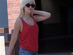 Get a boner watching this blonde babe, with small boobs wearing shorts, while she gets naked in public and touches herself fervently.