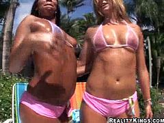 Two sizzling bitches wearing bikinis are having a great time with two dudes on the poolside. The men make the hussies suck their pricks and then they bang in cowgirl and other positions.