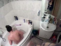 Bathing beauty filmed being naughty in bathtub