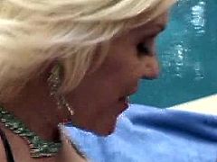 Click to watch these blonde cougars, with titanic bazookas and nice butts, while they get fucked hard outdoors next to a swimming pool.