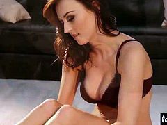 Lauren Wood highlights her best assets with the help of a dark colored lingerie and a pair of black platforms. She poses in different positions, teasing and revealing her boobies.