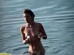 A dude films a slim blonde on a nudist beach. She gets in the water, sunbathes and puts sunscreen all over her body. Her tits are perky and her ass is nice too.