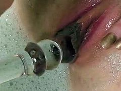 Holly Jane is a busty redhead who takes a bath. She fills the bathtub with water and foam before she begins to penetrate her pussy with a beaded dildo and use the water jet on it.