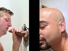 Take a look at this hot gay gloryhole scene where this horny twink sucks on this guy's big fat cock poking out of the wall.