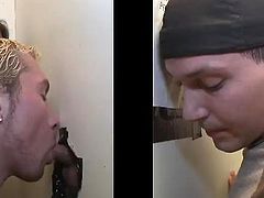 A kinky blond poofter is having a good time indoors. He finds a cock sticking out of a gloryhole and sucks it as best as he can.-